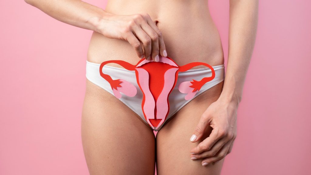 woman trying to conceive with endometriosis with picture of uterus in front of her pelvis